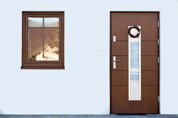Designer entrance door to a country house. Modern design. luxurious exterior. Facade of a modern building with modern doors.