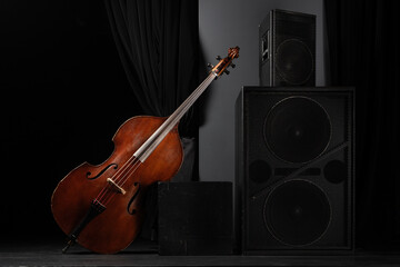 Beautiful classic double bass on the concert stage with acoustic speakers . Acoustic double bass on...