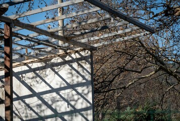 Scenic view of a metal construction under bare trees on a sunny autumn day
