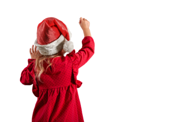 a Girl in santa claus hat draws christmas drawing on the blackboard