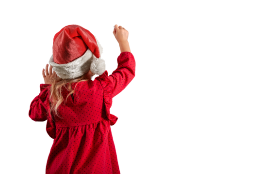 a Girl in santa claus hat draws christmas drawing on the blackboard