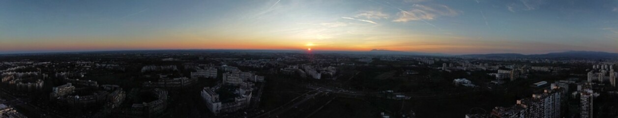 Aerial panoramic view of sunset over the bustling city