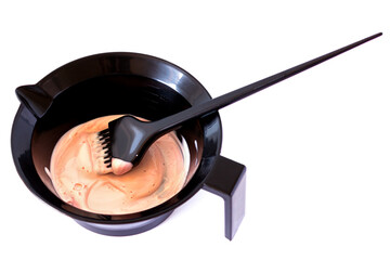 Mixing hair dye in a special plastic bowl. Accessories for hair coloring. Isolated on white.