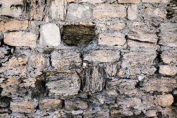 a large stone wall with a bricked up window and one bricked off