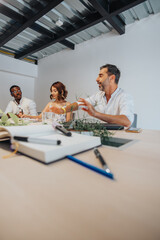Diverse group of business partners in a modern office discussing strategies, project management, profit growth.
