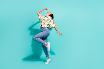 Full size photo of satisfied overjoyed woman dressed flower print blouse having fun dancing isolated on turquoise color background
