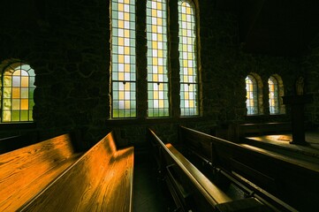 Beautiful old church illuminated by the sun streaming through the stained glass windows