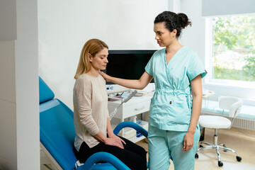 Empathic female gynecologist in medical uniform touch female patient arm show empathy and care.