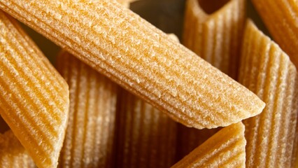 Closeup shot of raw whole wheat macaroni pasta.