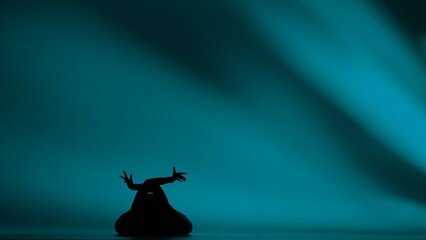 Woman silhouette dancing heels dance in a studio. Bright cyan, turqouise neon light, shadowed...