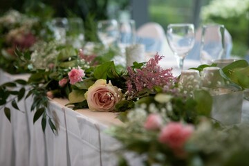 Tablecloths with vibrant pink flowers and lush greenery adorning the tables