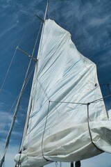 Sailboat with a white cloth draped across the front sails.