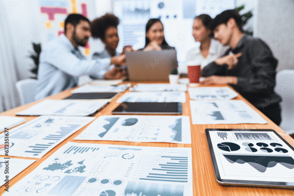 Poster focus financial dashboard paper showing graphs and chart with blurred background of diverse business