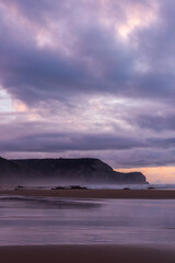 Sunset at sandy Cordoama Beach at Atlantic Ocean, Algarve, Portugal