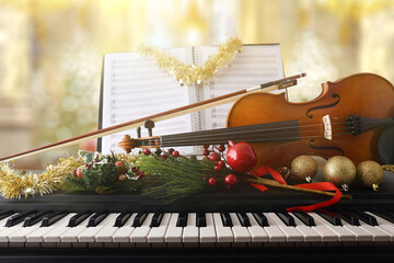 Piano and violin with christmas decoration in religious temple