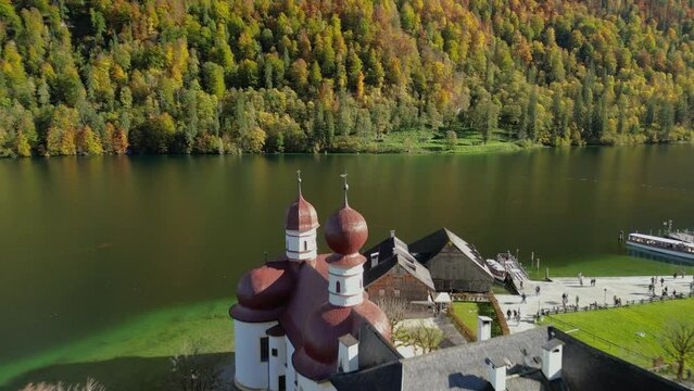 The drone aerial footage of Lake Konigsee with Sankt Bartholomae pilgrimage church and Watzmann mountain, Berchtesgadener land, Bavaria, Germany.