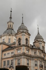 Fototapeta na wymiar Ancient La Granja de San Ildefonso royal palace in San Ildefonso, Spain against a clouded sky