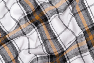 Crumpled texture of white, yellow and black tartan fabric. Image for your design. Traditional Scottish clothing and style