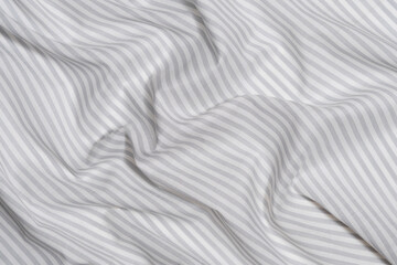 Fototapeta premium close-up texture of crumpled gray-white striped fabric. material for sewing clothes and textiles for the home, marine theme concept. Image for your design