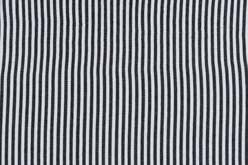 texture of knitted striped fabric in black and white colors. material for sewing clothes and textiles. background for your design