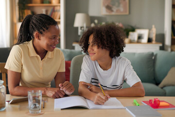 Mom helping a teenage son study for exam at home