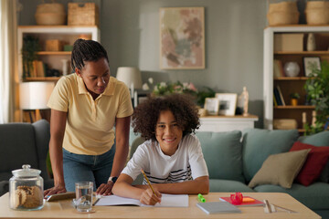 Fototapeta premium Mom helping a teenage son study for exam at home