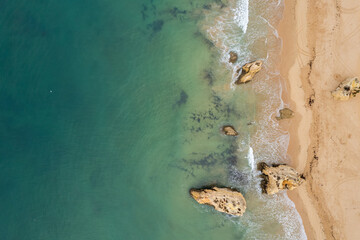 Aerial drone view of  sandy beach of Praia da Rocha and Atlantic Ocean waves, Algarve,Portugal