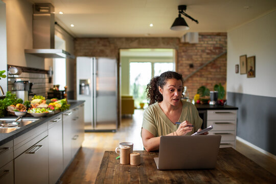 Female nutritionist offering advice on laptop video call at home