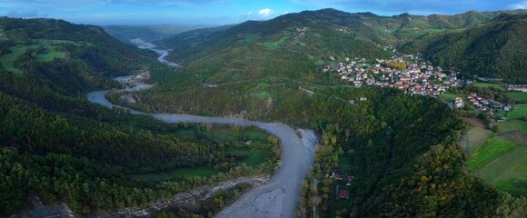Fototapeta na wymiar A panoramic aerial view of the Enza River near the village of Vetto d'Enza and the Vetto Dam. Reggio Emilia, Emilia Romagna, Italy