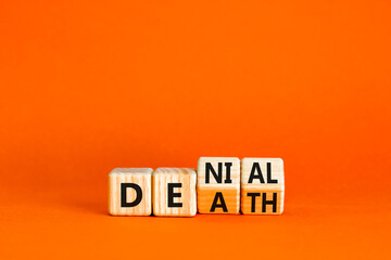 Denial death symbol. Concept words Denial Death on wooden block. Beautiful orange table orange...