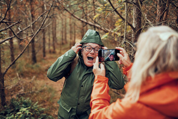 Senior woman posing for picture on a nature hike