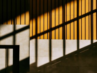 Beautiful yellow wooden wall with a shadow of railings on it