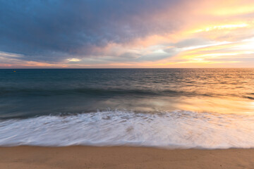Naklejka na ściany i meble Sunset at sandy beach on Altantic Ocean coast in Portugal