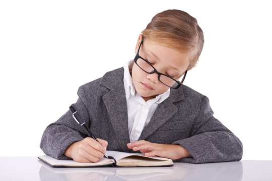 Business kid in suit, writing at desk and book for learning, education and study. Girl, child and notebook at table, professional working and serious student isolated on a transparent png background