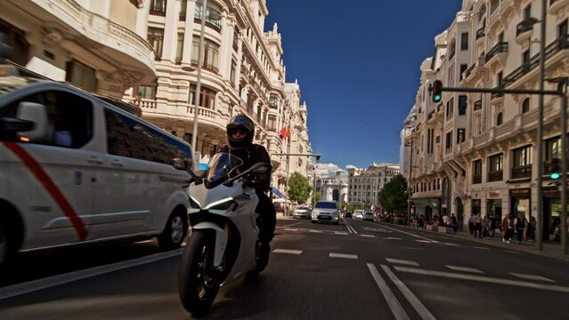 Man riding supersport motorcycle on the street of Madrid on a beautiful sunny day	