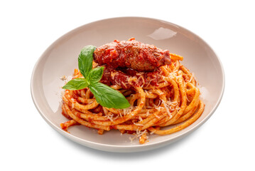 Bucatini pasta with meat rolls and tomato sauce and basil leaves and parmesan cheese in white plate isolated