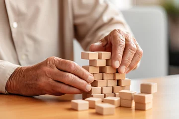 Foto op Canvas Faceless Senior man with dementia playing with wooden blocks in geriatric clinic or nursing home © colnihko