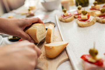 Close up of woman's hand preparing canape.