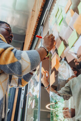 Diverse business professionals brainstorming, collaborating, and problem-solving in a modern...
