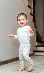 A Curious Little Boy Exploring the World Around Him. A little boy that is standing up in a room