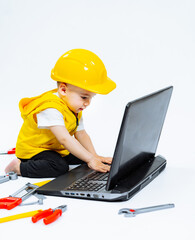Child Exploring the Digital World with Curiosity and Safety. A small child wearing a hard hat using a laptop