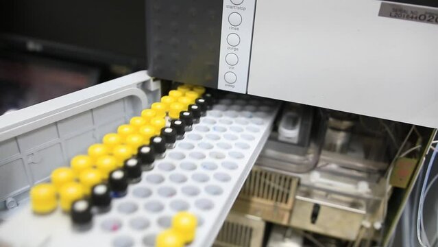A tray with samples and reference standards is placed in a laboratory chemical equipment intended to find trace levels of contaminants in food, water and biological samples as blood and urine