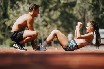 Caucasian couple exercising outdoors in a sunny park. They focus on core and abs workouts. Their fit bodies and strong muscles demonstrate their dedication to fitness.