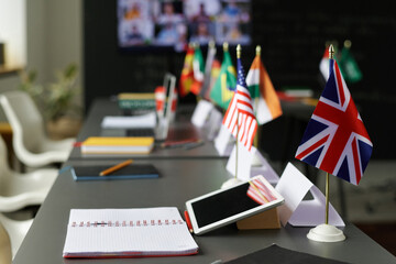 Close-up of table with flags of different countries on it in the classroom at school