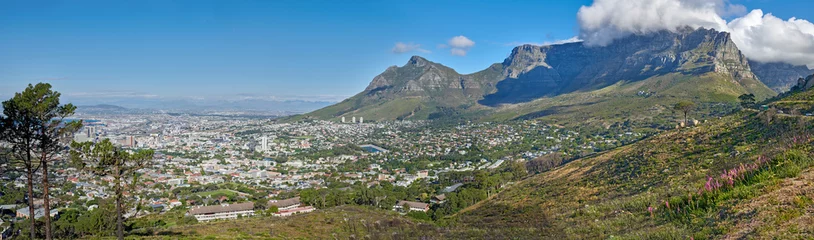 Wall murals Table Mountain Panoramic landscape view of the majestic Table Mountain and city of Cape Town in South Africa. Beautiful scenery of a popular tourist destination and national landmark with cloudy blue sky copy space