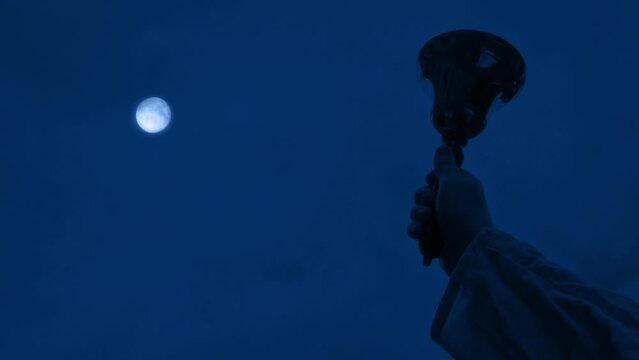 Man Rings Bell With Moon Above