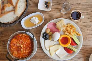 turkish breakfast of menemen cheese, cucumber, egg, olive and tomato