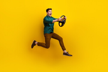 Photo of funky cheerful man in trendy clothes test drive lesson speed vehicle road looking empty space isolated on yellow color background - obrazy, fototapety, plakaty