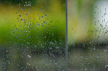 Rain falling on glass, textured background. Winter concept