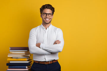 portrait of a man with books in front of a back yellow plan, learning, education, studies